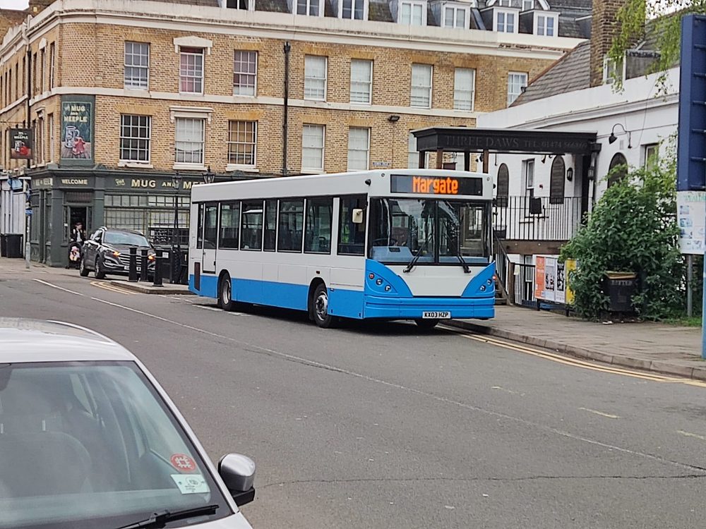 White and blue bus with a Margate destination display parked on a town street