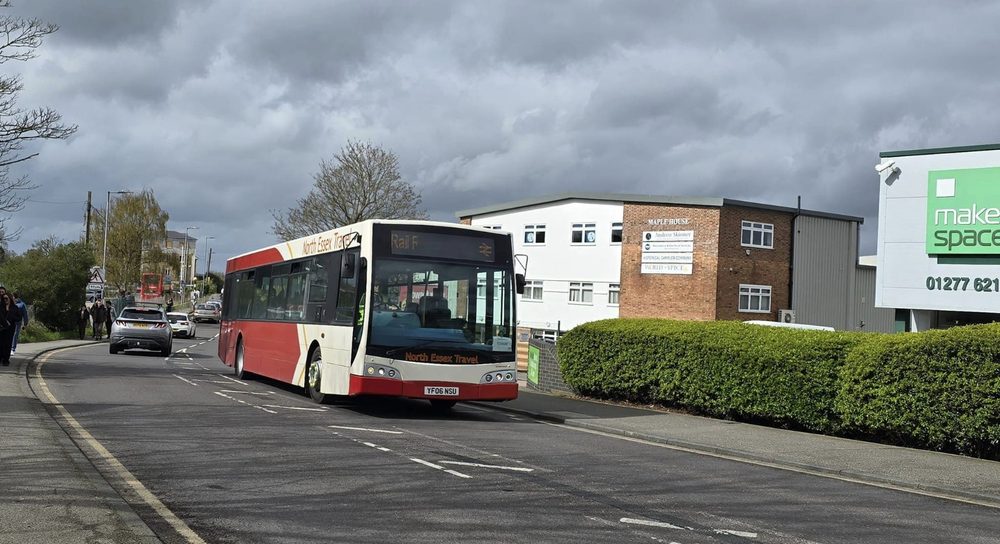 Red and cream North Essex Travel bus parked in a car park